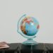 A globe and passport on a suitcase, symbolizing travel planning and wanderlust.